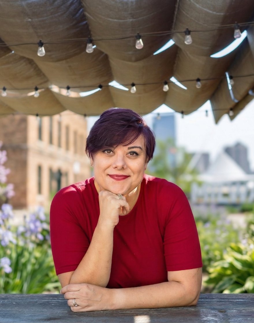 Hazel Quimpo, founder of Practice Presence, in a warm portrait on a rooftop patio with greenery