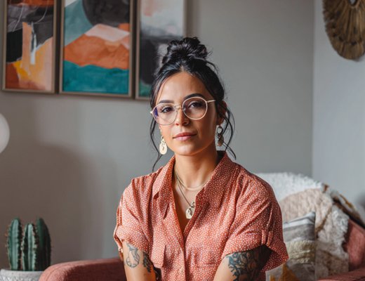 Latina therapist in a beautifully styled office with plants and warm textiles